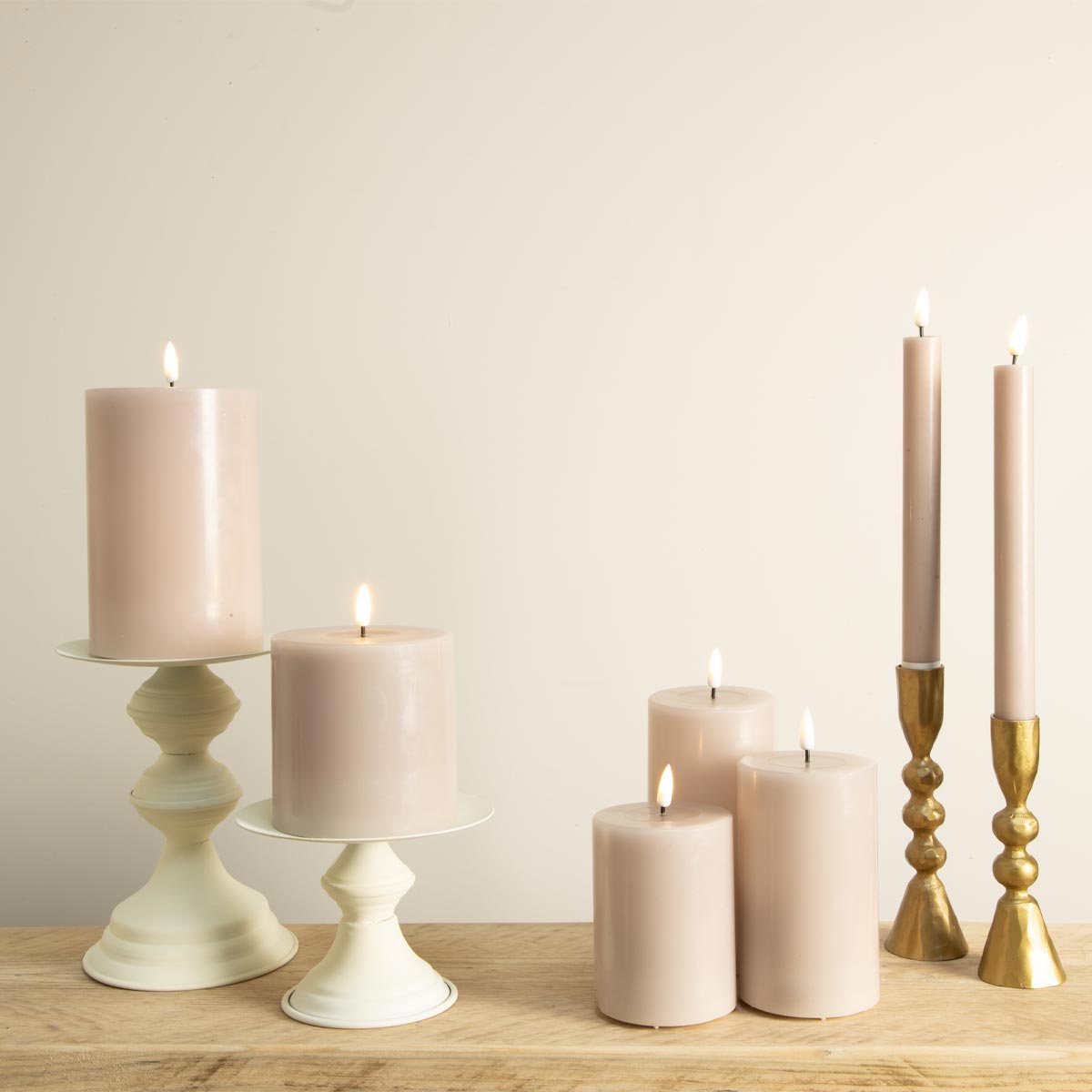 Rose LED candle collection with dinner and pillar candles on white and gold candlesticks