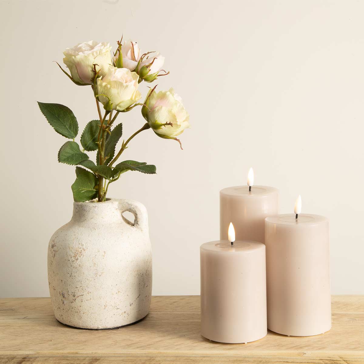 Rose LED pillar candles styled with cream ceramic jug and faux flowers