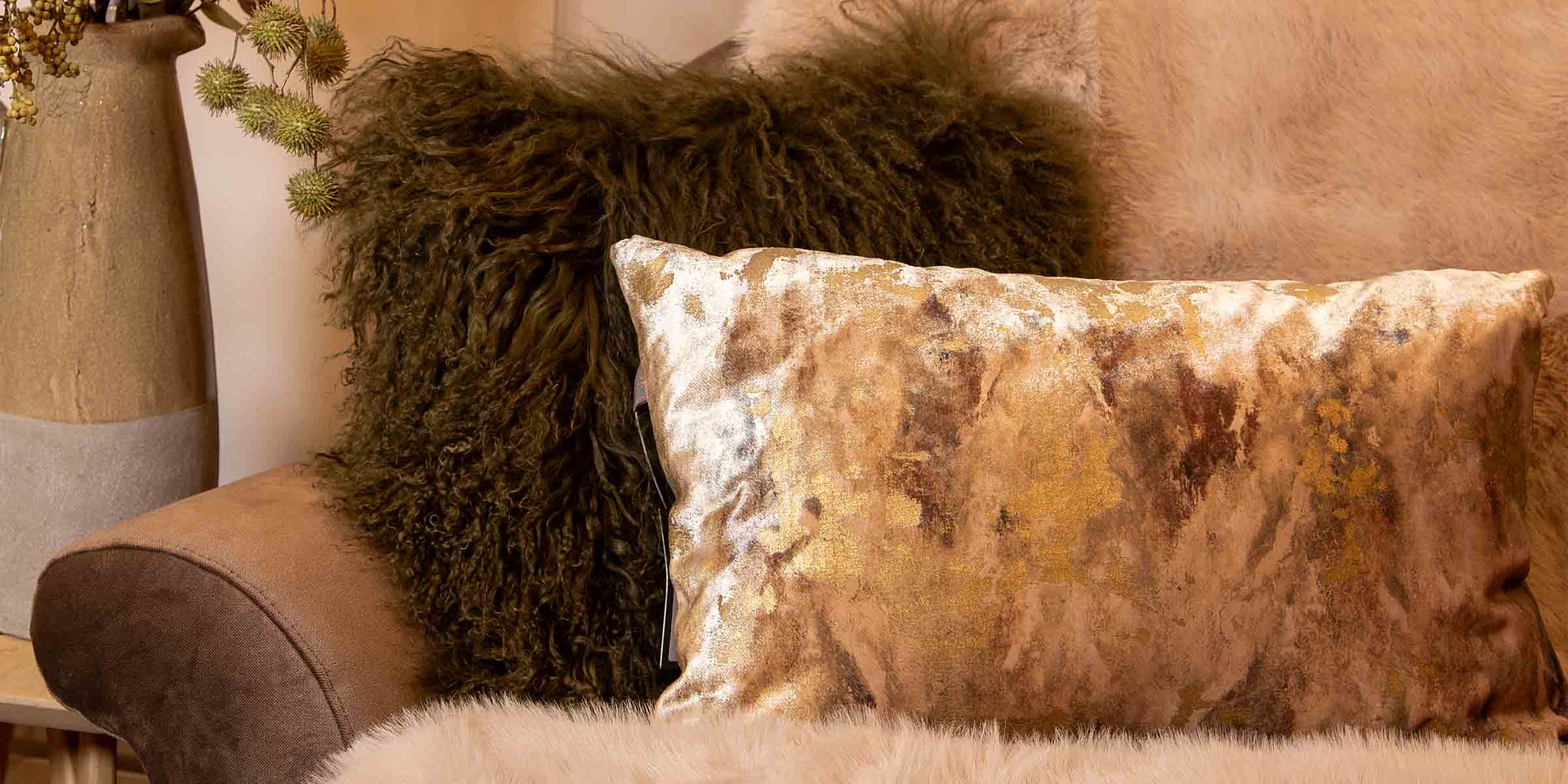 Gold Patterned Cushion and Green Sheepskin Cushion on Sofa