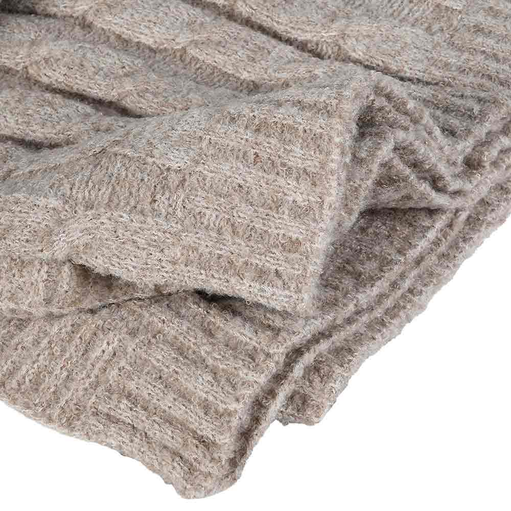 A close-up of a folded chunky knit blanket in a heathered taupe-beige color, showing the soft mohair-like texture against a plain white background.