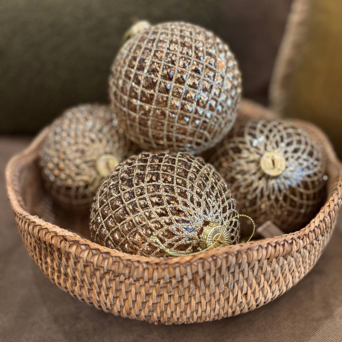 Bronze Diamond Round Bauble in a woven basket on a soft brown background