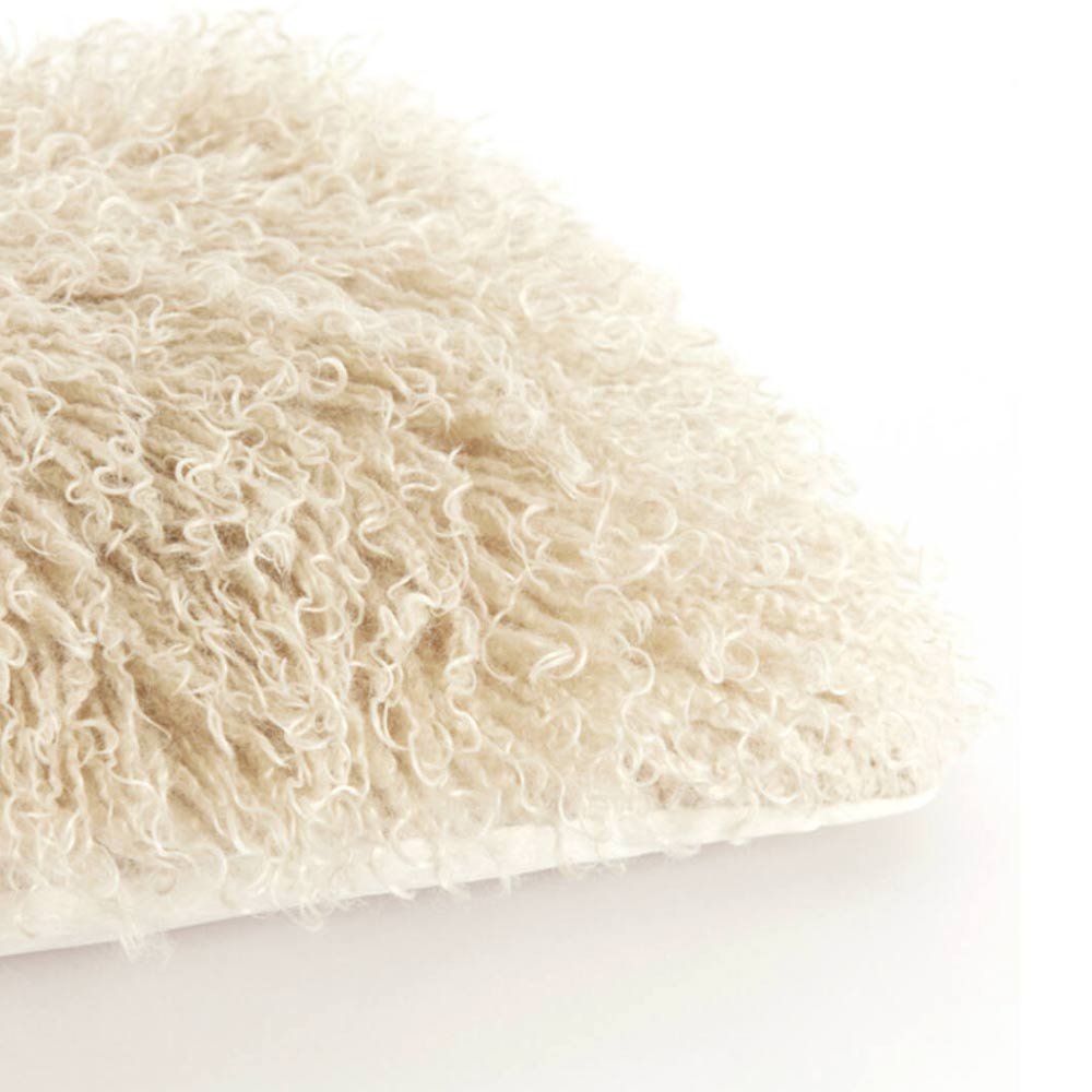 Close-up of a stone faux fur oblong cushion with soft shaggy texture on a white background