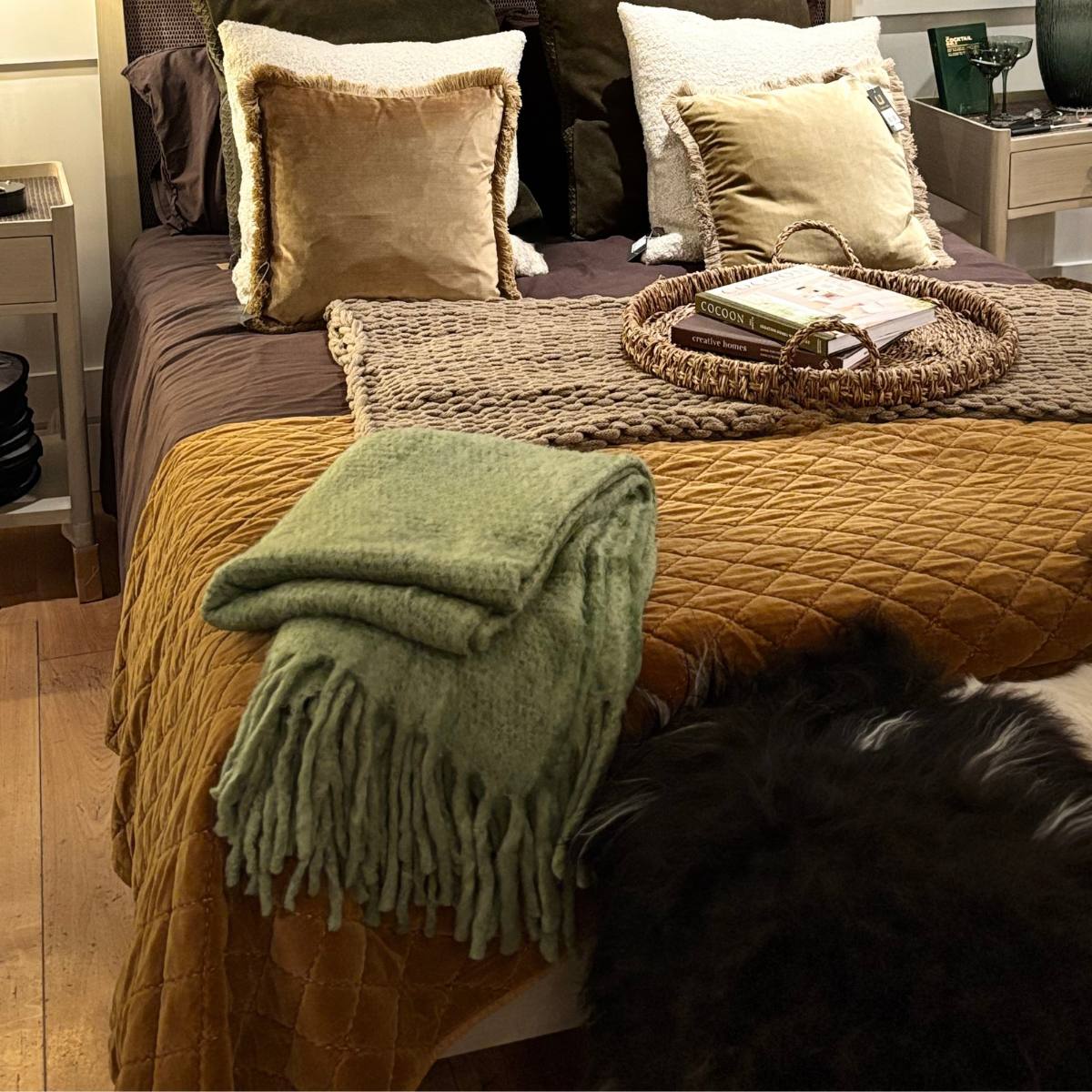 Bed with Caramel Bed Spread - King Size, green throw blanket, and decorative pillows in a bedroom setting.