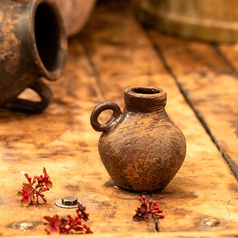 Daiane Small Brown Terracotta Vase with Single Handle on a wooden table