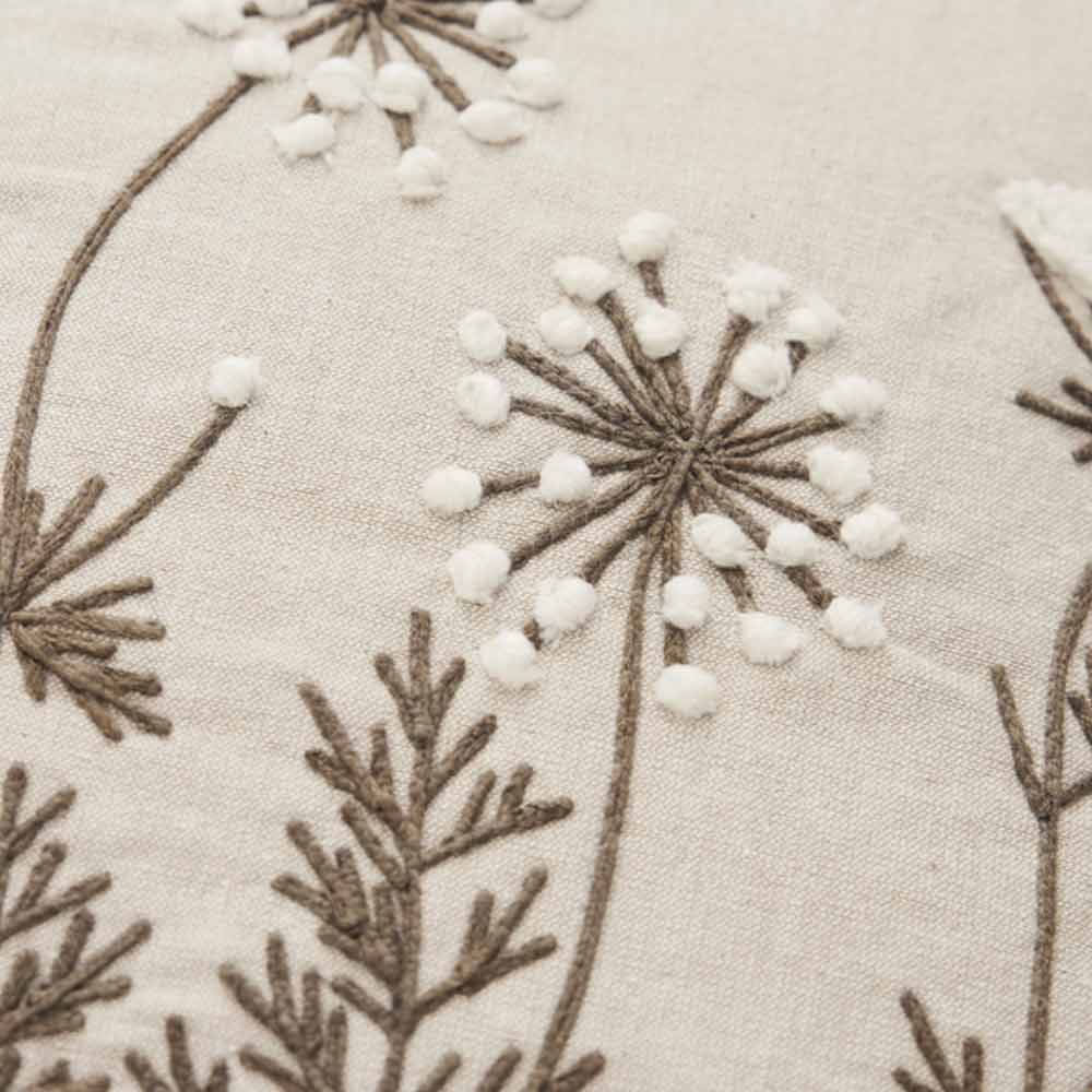 Close up of Emilde Cushion in Linen and White floral embroidery