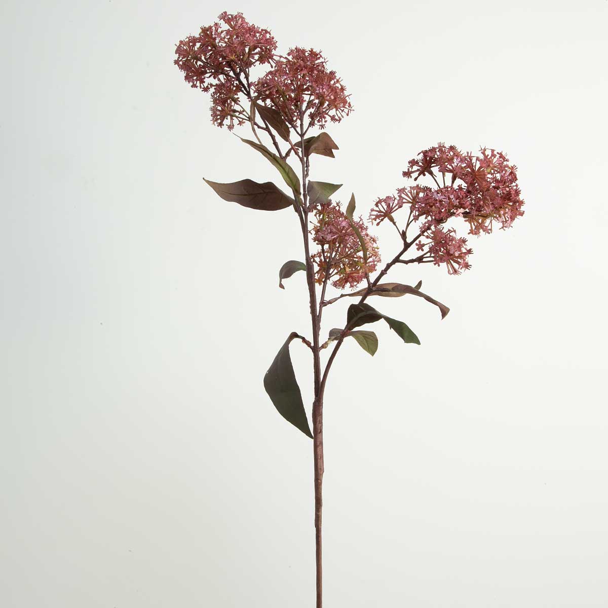 A single artificial burgundy smokebush stem with green leaves and purple flowers against a white background.