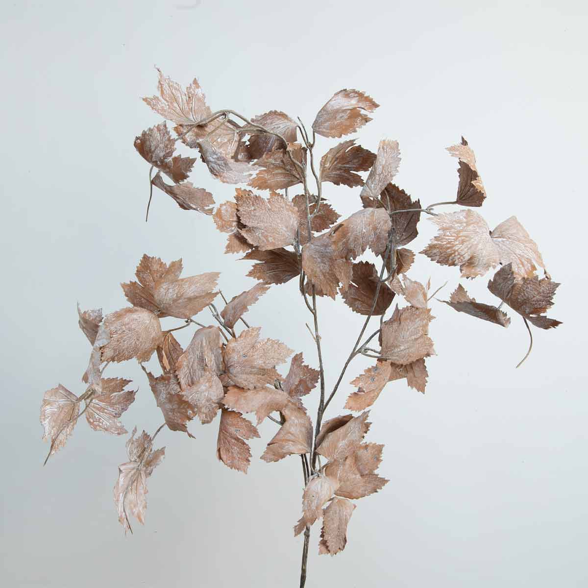 A spray of artificial dried vine leaves against a light background.