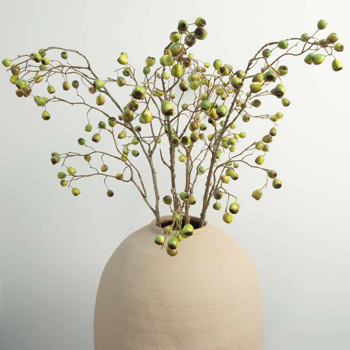 A display artificial dual tone eucalyptus berry stems in a ceramic vase.