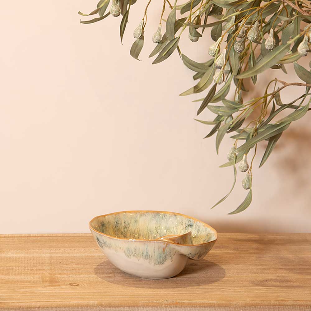 Green Ombre Shell Effect Bowl gold rim on a wooden surface with greenery in the background