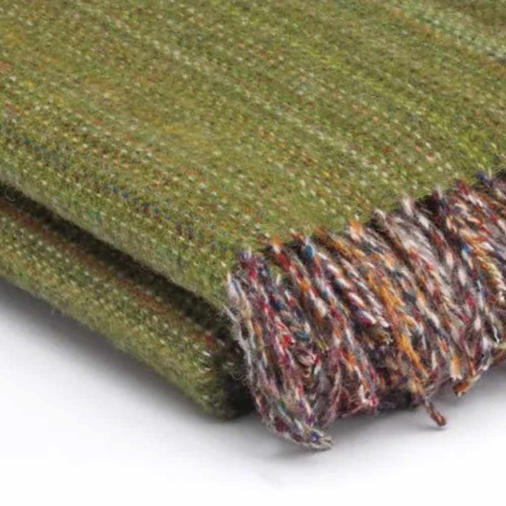 Close-up of a fabric - Heritage Meadow Green Tweed, Pure Merino Wool Throw by McNutt of Donegal with fringed edge on a white background