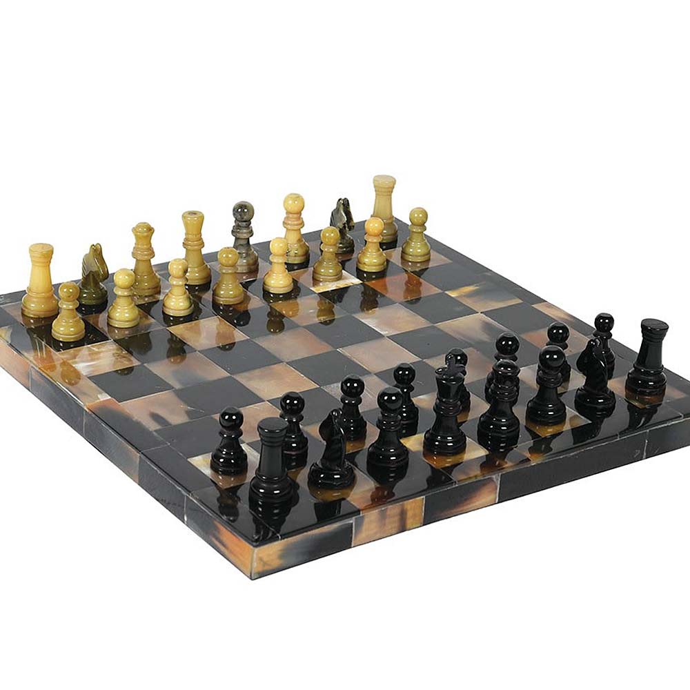 A polished tortoiseshell chess set with black and cream-colored wooden pieces arranged on a matching checkered board against a plain white background.
