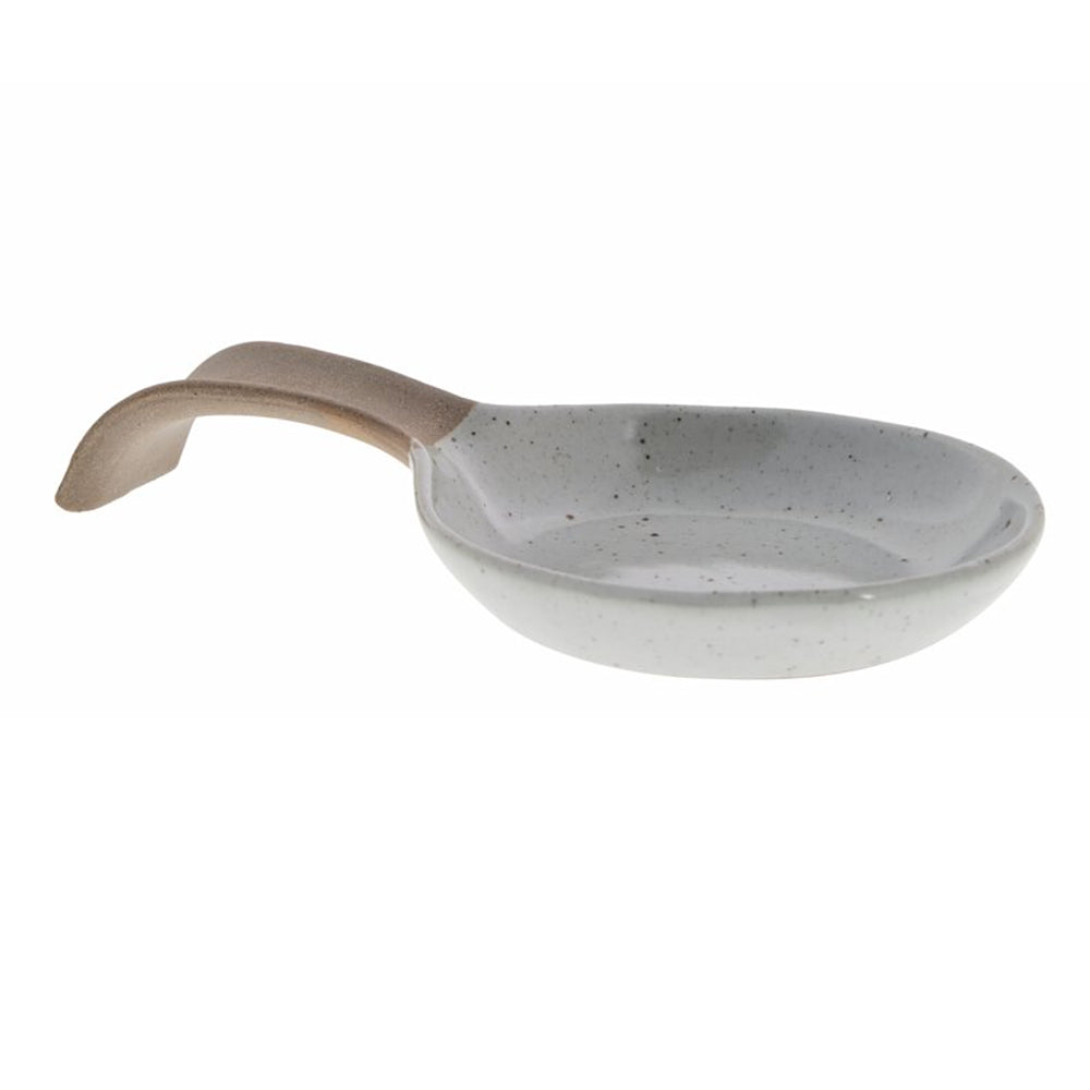 Brown-grey speckled stoneware spoon rest with curved shape and a beige handle on a white background