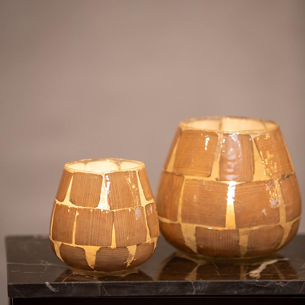 Two Kuala  Glass votives on a marble surface with a neutral grey background