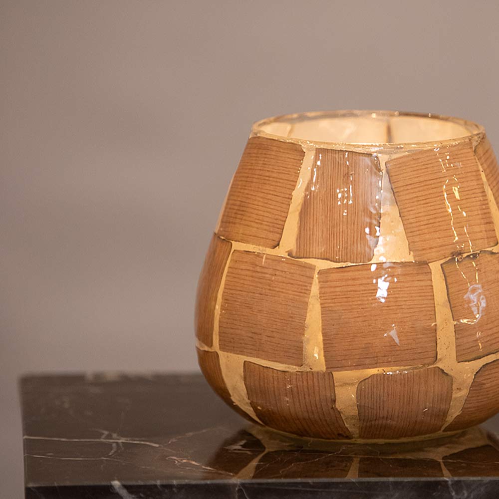Close up of a Kuala Glass votives on a marble surface with a neutral grey background