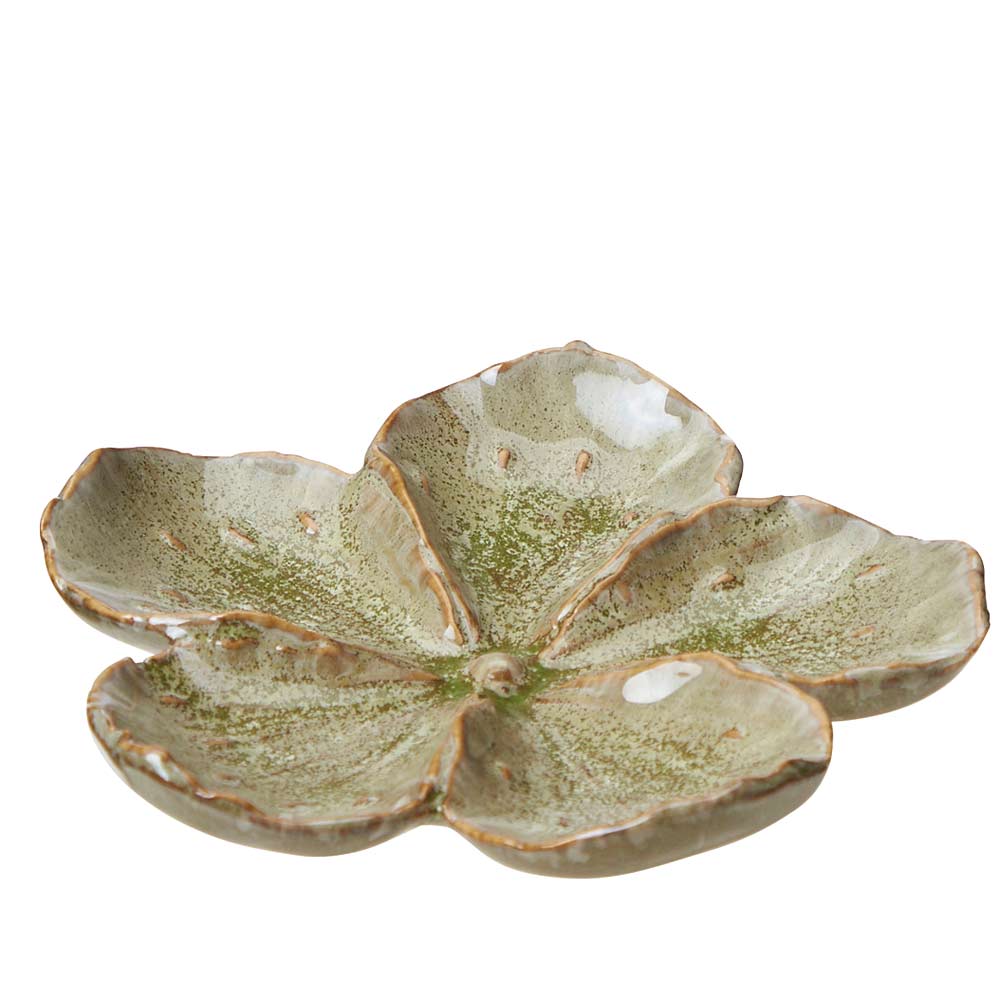 A five-petal ceramic dish with a glossy, textured glaze in muted green and beige tones, set against a plain white background.