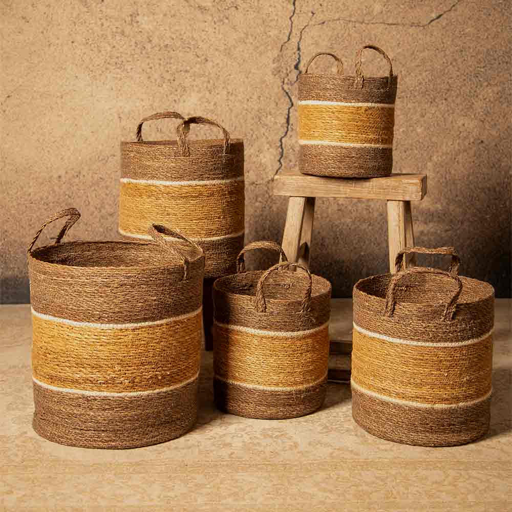 Set of woven baskets with striped design on a textured surface