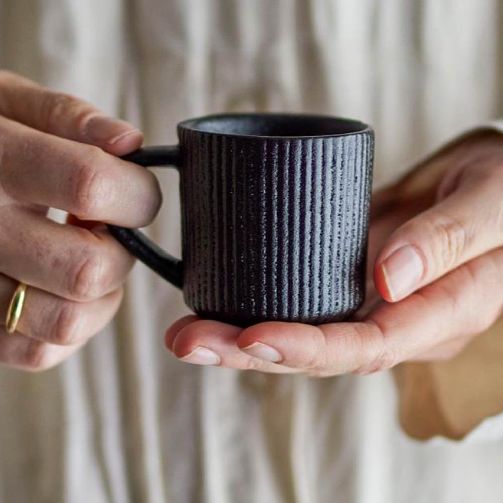 Neri Stoneware Espresso Cup in Black textured black mug against a neutral background