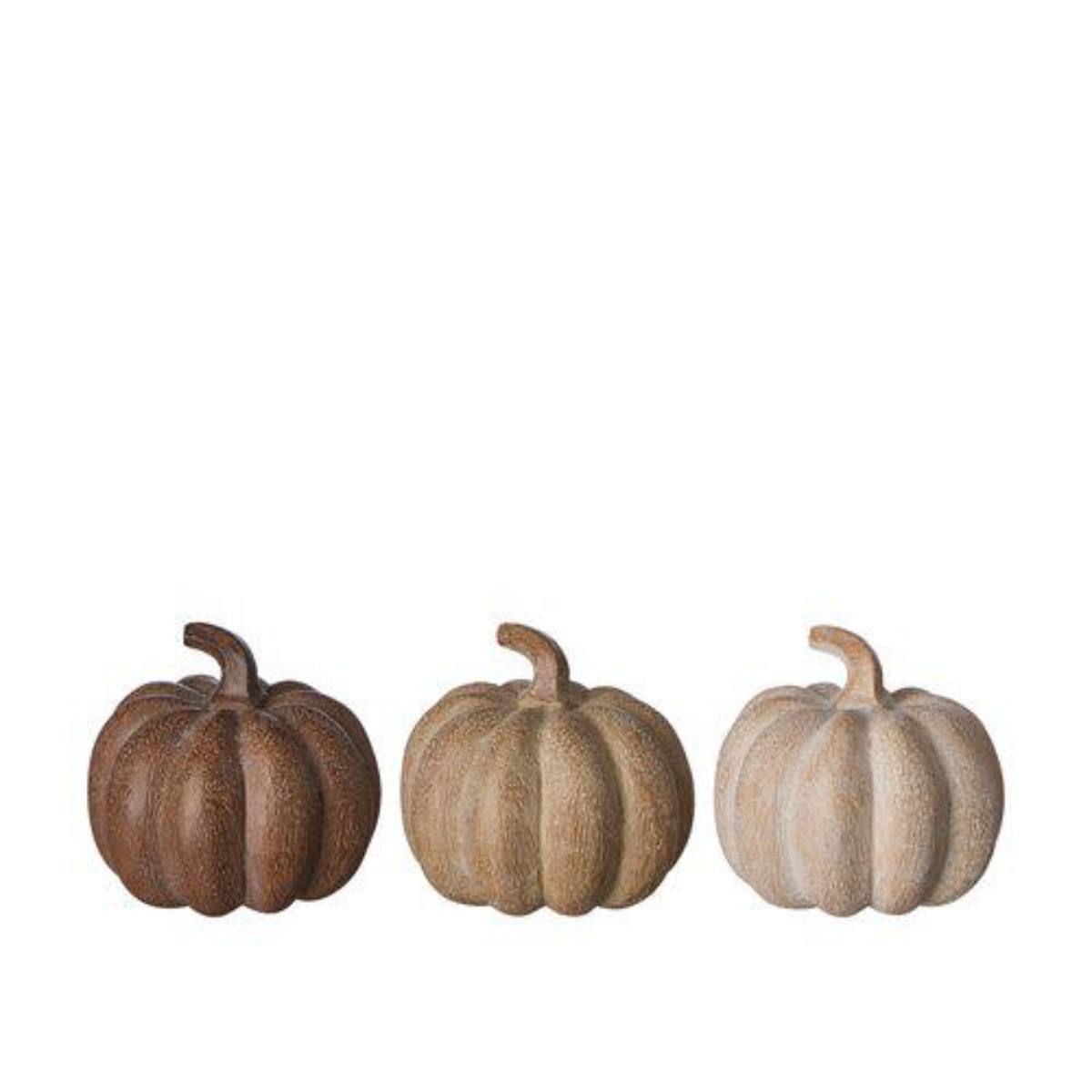 Three decorative ceramic pumpkins in different shades of brown on a white background