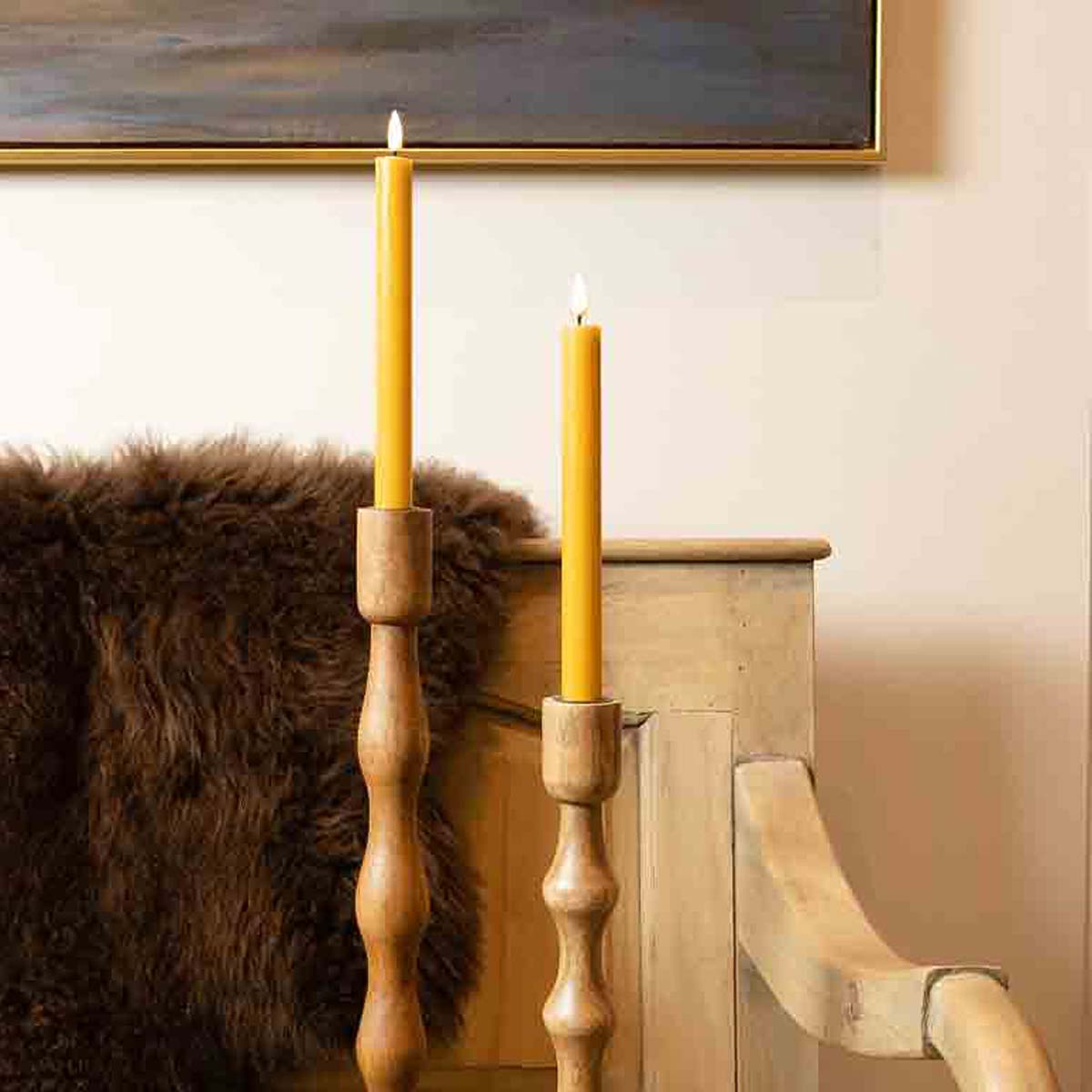 Saffron LED Dinner Candles- Set of 2 - displayed in rustic wooden candle holders on bench