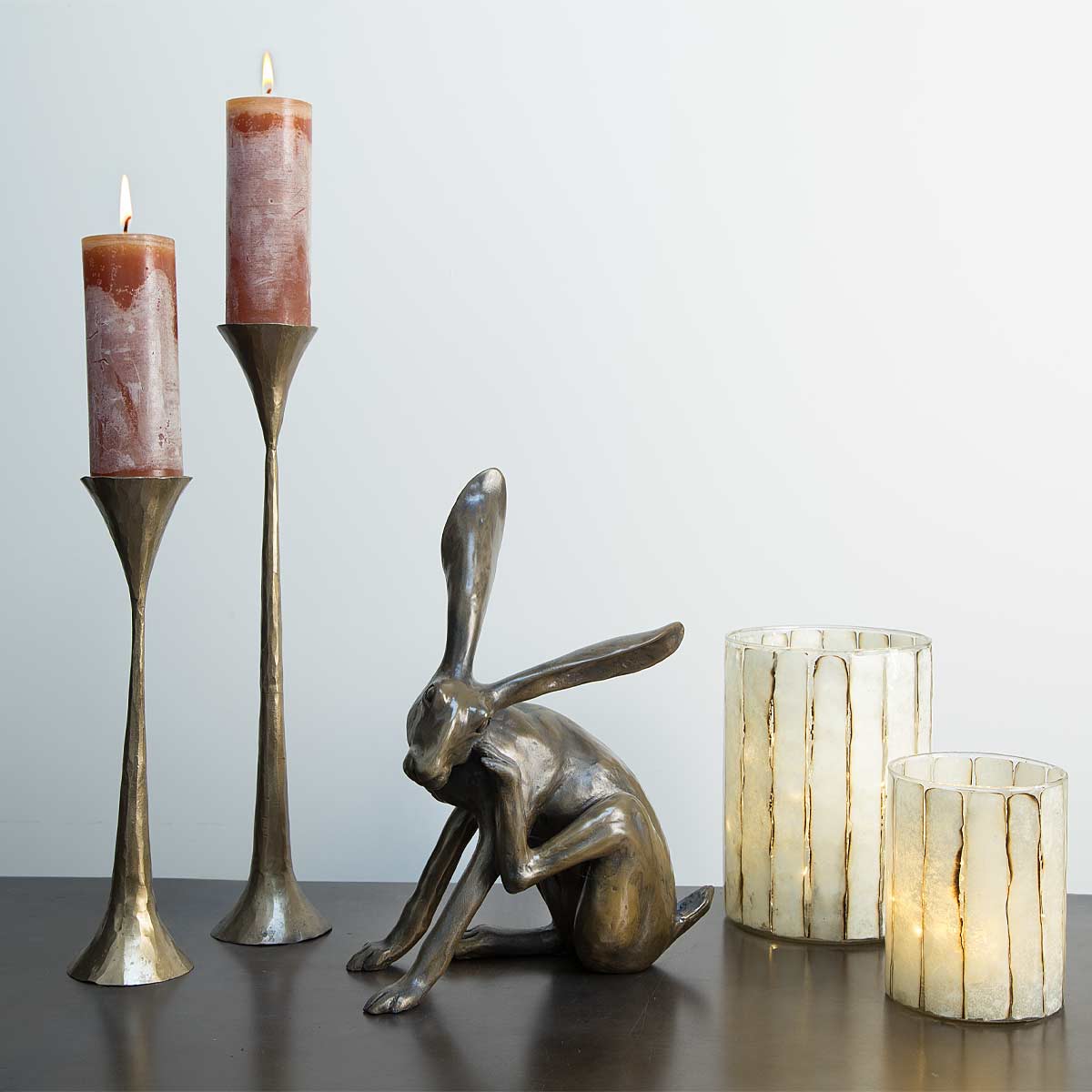 Scratching Hare bronze resin sculpture handmade in the UK – Joanna Martins design. Displayed with candles