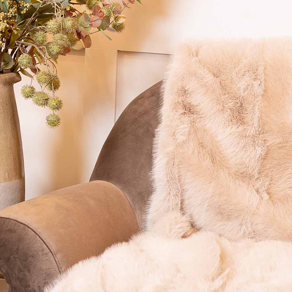 Close-up of Sloane Mink Faux Fur Throw on armchair