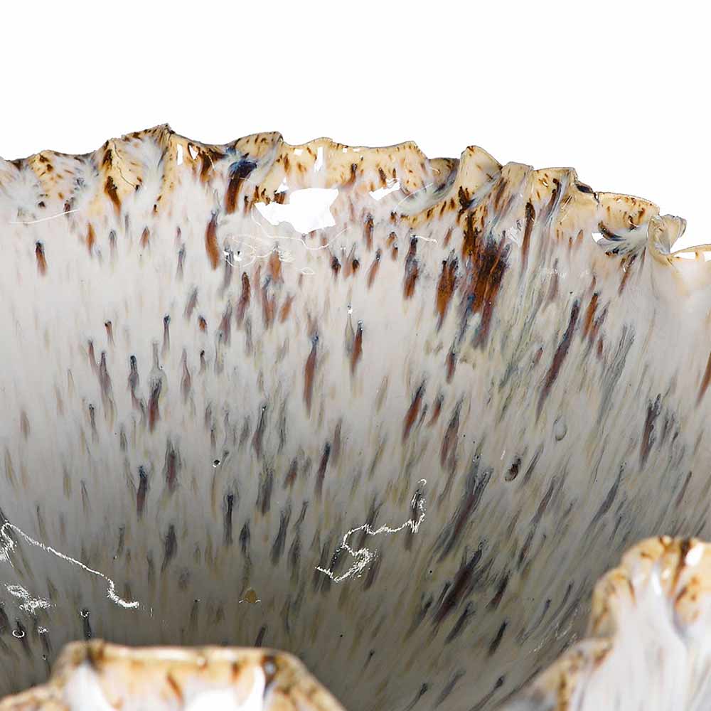Close-up of a textured ceramic bowl or vase with a flared, organic rim, featuring a speckled pattern of brown, beige, and gray on a white base.