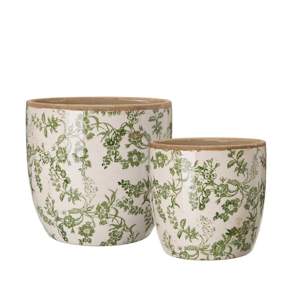 Two ceramic planters with green floral patterns on a white background