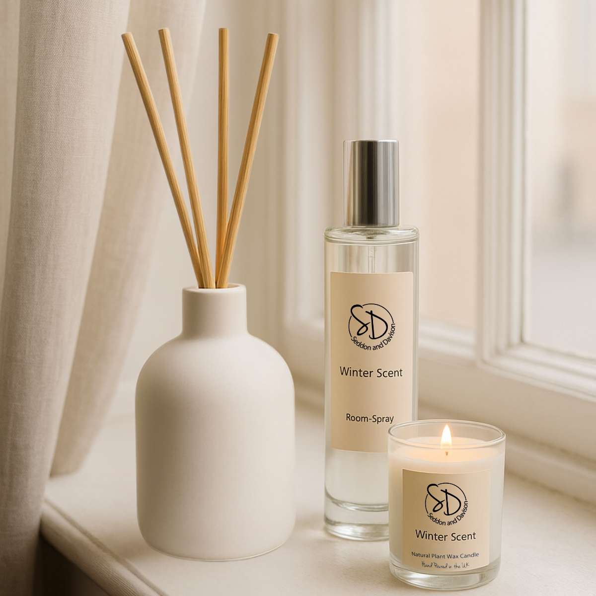 Winter Scent Reed Diffuser in Ceramic Bottle displayed on window sill with room spray and votive