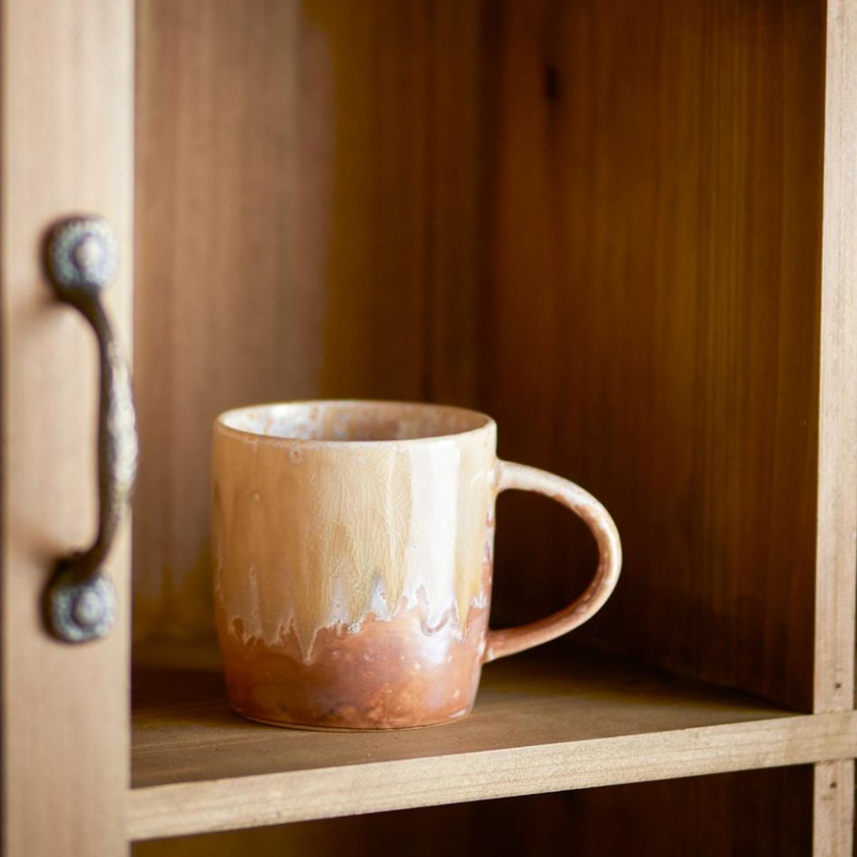 Milani stoneware mug with natural reactive glaze displayed on a wooden shelf